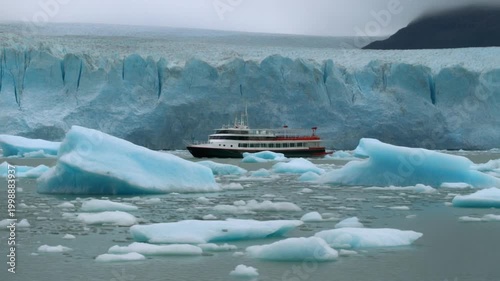 Tourist boat cruising past the massive Perito Moreno Glacier