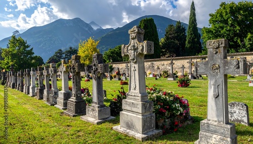 Scenic cemetery scene featuring stone crosses in a row, with a mountain range in the backdrop, and vibrant floral arrangements