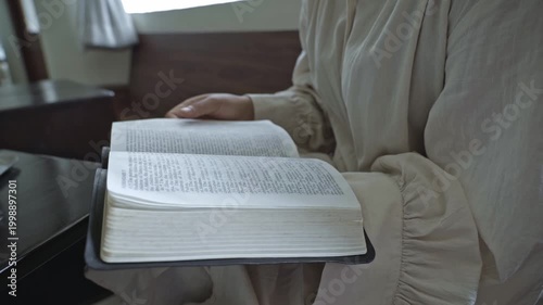 young asian Woman Reading the Bible at indoors daytime