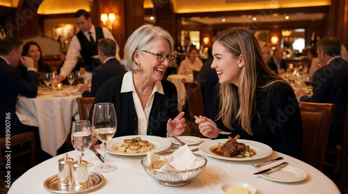 Grandmother and her grandson are eating in a restaurant while laughing