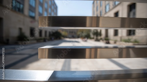 Modern minimalist horizontal slat barrier construction against a blurred urban building background