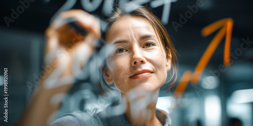 Strategist sketching growth arrow ending at 2026 on transparent board representing forward planning business forecasting and corporate strategy