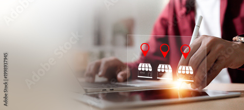 Small business store finding and location based service concept with businessman touching virtual shop icons on tablet.