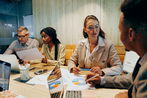 Photography Multiracial team negotiating project details in meeting