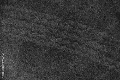 Close up black tire marks on cement floor.