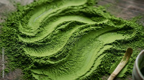 Green powder texture with flowing wave pattern on wooden surface, abstract organic surface with spoon detail