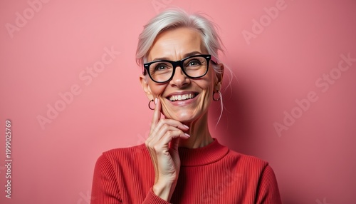 Smiling elderly woman in red against pink background with copy space for text