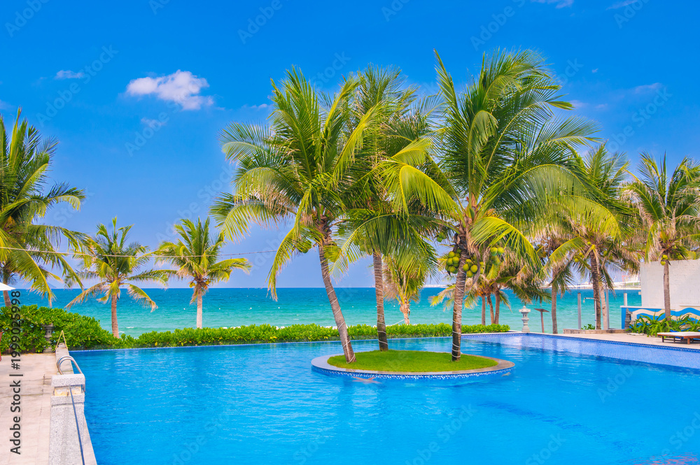 Obraz premium landscape with an infinity swimming pool on beach with palm trees by the sea in luxury hotel in a resort in tropics in Asia in summer