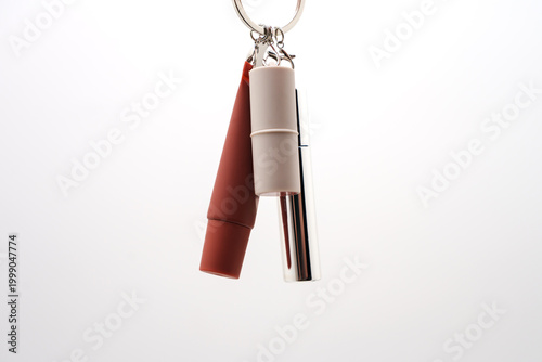 Bild auf Leinwand Keychain with mascara lipstick and lip gloss on white