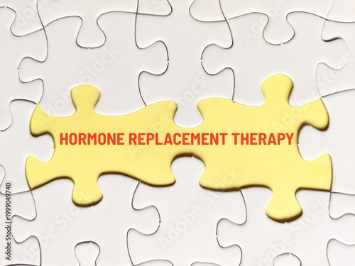business concept puzzle. Jigsaw puzzle and yellow background with the word hormone replacement therapy