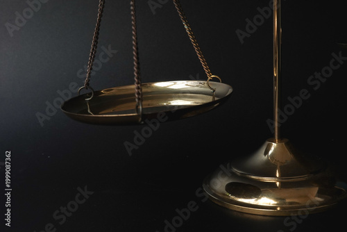 Photos Close up of golden scale justice scale plates symbolizing careful consideration, balance of interests, and precise legal evaluation