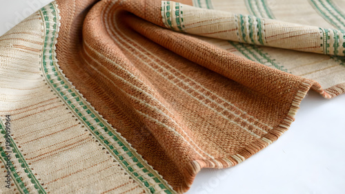 Textile Texture: A close-up shot of a meticulously woven fabric, showcasing its intricate textures and the interplay of color and pattern. Emphasizing the craft and quality of the textile.