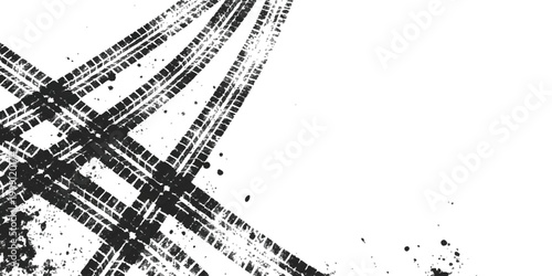 Black tire tracks cross pattern on ground surface creating a geometric shape
