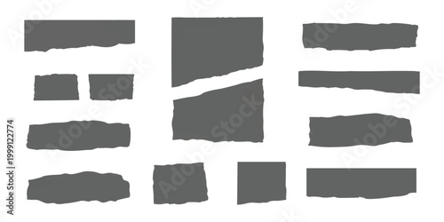 Set of grey ripped paper pieces and torn paper strips with rough edges isolated on a simple neutral surface