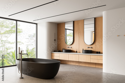 Foto Modern bathroom interior with dark freestanding bathtub, wood vanity, large mirrors and panoramic window view highlighting serene design