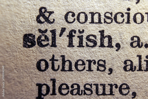 Fotografia Word selfish on dictionary page, macro close up