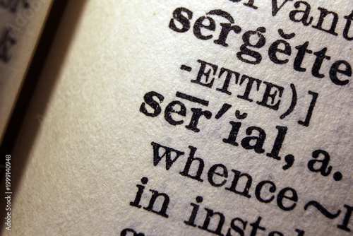 Foto Word serial on dictionary page, macro close up