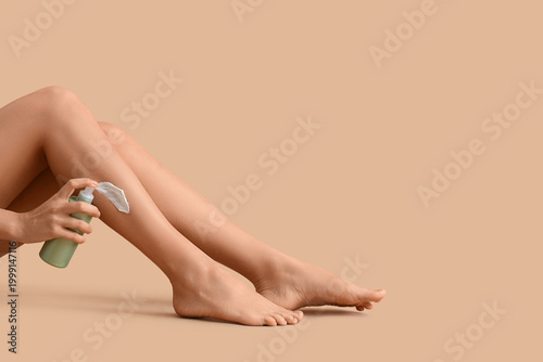 Woman applying cream to her...