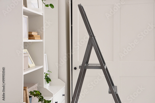 Photos Interior of living room with stepladder and shelf unit