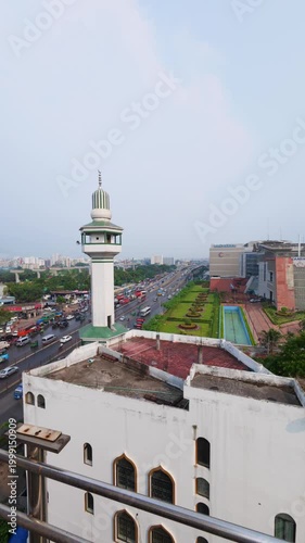 High-Angle View of a Mosque Minaret Overlooking Busy City Traffic and Urban Architecture in Dhaka, Bangladesh