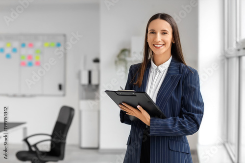 Female business consultant with clipboard in office