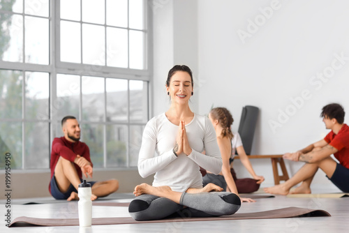 Sporty young woman meditati...
