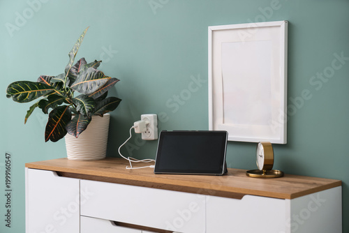 Modern tablet with charger ...