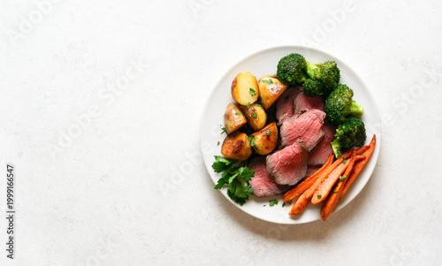 Sunday Roast with roasted beef, carrots, crispy potato and broccoli