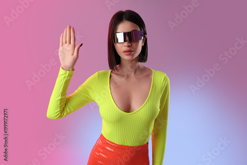 Young woman in VR glasses o...