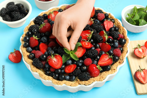 Woman decorating sweet tart...