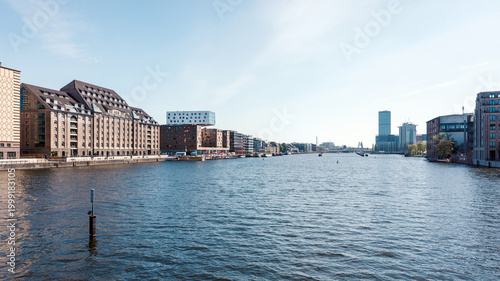 Tableau sur toile Wide view of Berlin Spree River with waterfront buildings on both banks under bl