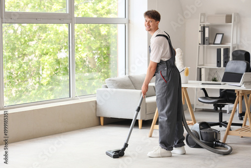 Young male janitor with mod...
