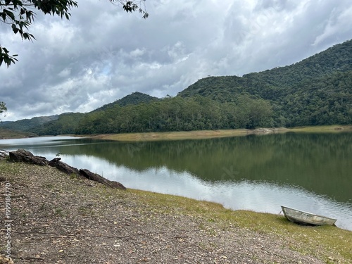 Принти на полотні Tranquil lake reflecting soft hills, calm waters shimmering under gentle daylight, capturing the peaceful charm of Lagoa Alto Bananeiras in Brazil