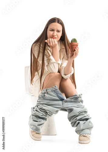 Young woman with cactus sit...