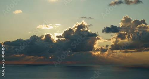 time-lapse of evening clouds and sunlight over the sea