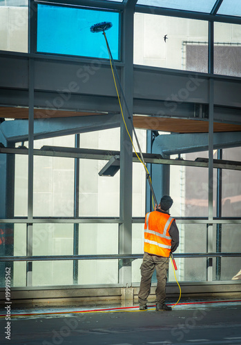 Professional high window cleaning with extendable water-fed pole