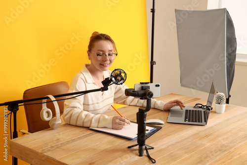 Female blogger with laptop ...