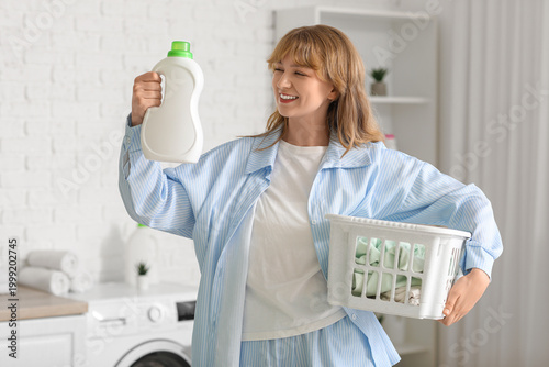 Young woman with laundry ba...