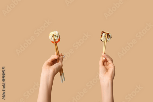 Female hands holding chopst...