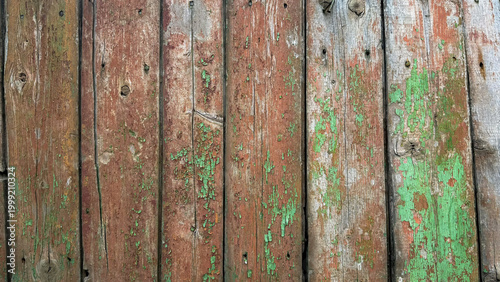 Obraz na płótnie Old wooden planks with peeling green and brown paint create a rustic texture