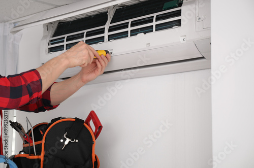 Male technician repairing a...