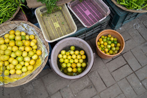 Overhead view of fresh citrus fruits in baskets and containers at a market