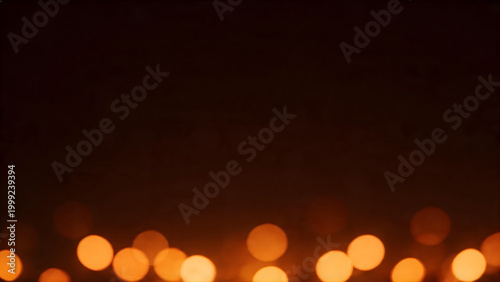 Abstract warm orange bokeh lights on a dark blurred background with copy space