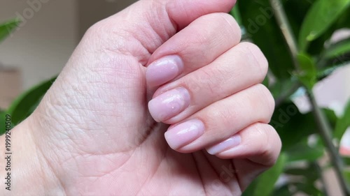 Woman showing her hands with grown out nail polish. Manicure concept