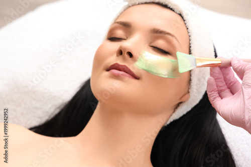 Young woman receiving facia...