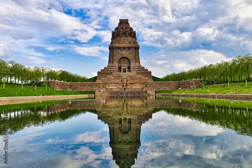 Monument to the Battle of the Nations in Leipzig, Germany, with beautiful water reflection under a dramatic sky