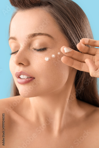 Young woman with facial cre...