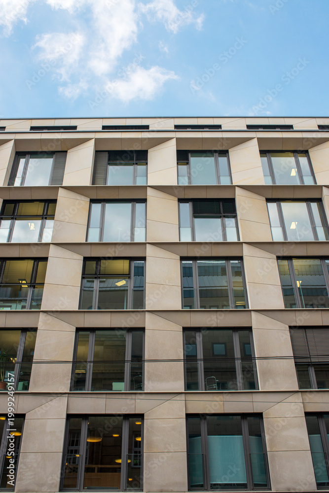 Fototapeta premium Modern apartment building facade with geometric window pattern