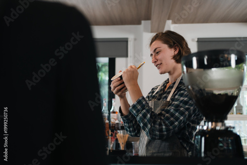 Coffee shop worker preparin...