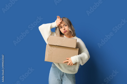 Tired woman with cardboard ...